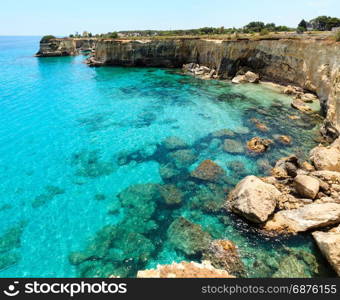 Picturesque seascape with cliffs and stacks (faraglioni), at Torre Sant Andrea, Salento sea coast, Puglia, Italy