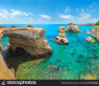 Picturesque seascape with cliffs, rocky arch and stacks (faraglioni), at Torre Sant Andrea, Salento sea coast, Puglia, Italy