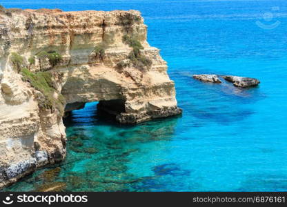 Picturesque seascape with cliffs, rocky arch and stacks (faraglioni), at Torre Sant Andrea, Salento sea coast, Puglia, Italy