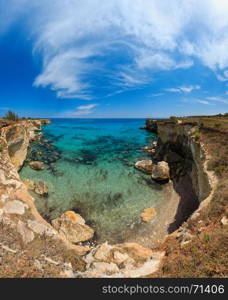 Picturesque seascape with cliffs, rocky arch and stacks (faraglioni), at Torre Sant Andrea, Salento sea coast, Puglia, Italy.