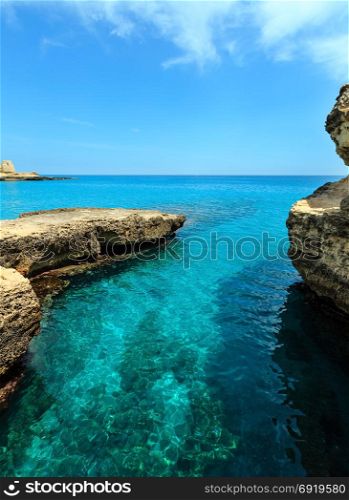 Picturesque seascape with rocky cliffs, caves, sea bay at Grotta della poesia, Roca Vecchia, Salento Adriatic sea coast, Puglia, Italy