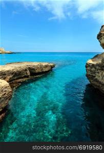 Picturesque seascape with rocky cliffs, caves, sea bay at Grotta della poesia, Roca Vecchia, Salento Adriatic sea coast, Puglia, Italy