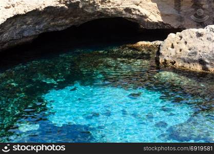 Picturesque seascape with white rocky cliff, cave and sea bay at Grotta della poesia, Roca Vecchia, Salento, Adriatic sea coast, Puglia, Italy.
