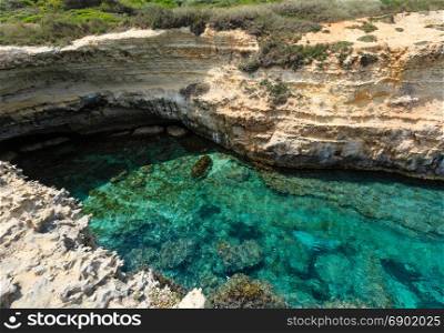 Picturesque seascape with white rocky cliffs and sea bay (Grotta dello Mbruficu, Salento Adriatic sea coast, Puglia, Italy).