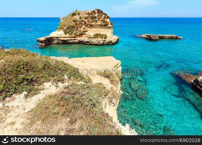 Picturesque seascape with white rocky cliffs, sea bay and islets at Grotta dello Mbruficu, Salento Adriatic sea coast, Puglia, Italy
