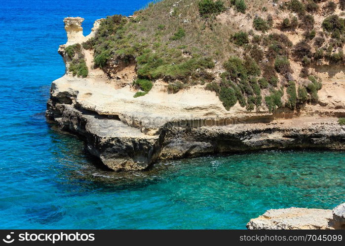 Picturesque seascape with white rocky cliffs, sea bay and islets at Grotta dello Mbruficu, Salento Adriatic sea coast, Puglia, Italy