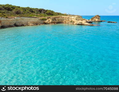 Picturesque seascape with white rocky cliffs, sea bay, islets and faraglioni at beach Spiaggia della Punticeddha, Salento Adriatic sea coast, Puglia, Italy