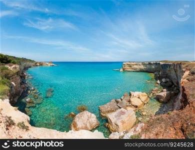 Picturesque seascape with white rocky cliffs, sea bay, islets and faraglioni at beach Spiaggia della Punticeddha, Salento Adriatic sea coast, Puglia, Italy