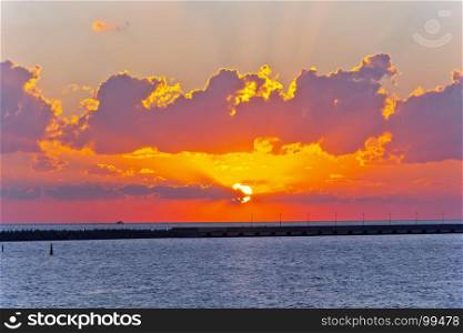 Picturesque skyscape of evening sea with red sunset