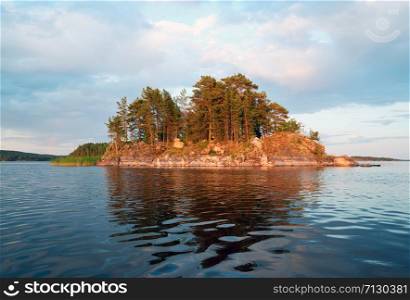 Picturesque stone shore of the island on the lake . Ladoga Skerries, Karelia.. Picturesque coastline of the island with a reflection on lake Ladoga .