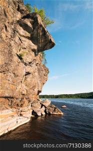 Picturesque stone shore of the island on the lake . Ladoga Skerries, Karelia.. Stone cliff on the shore of lake Ladoga .