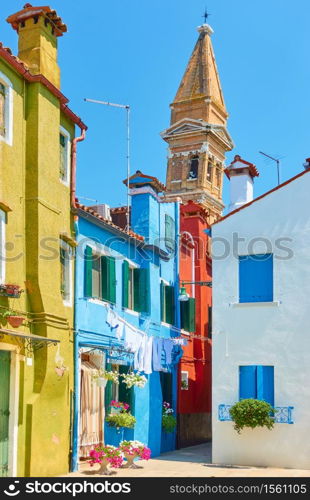 Picturesque street and leaning old bell tower in Burano in Venice, Italy - Italian cityscape