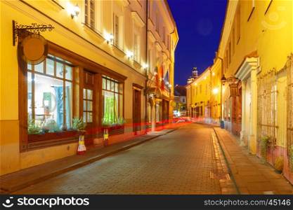 Picturesque Street and luminous track from the car at night in Old Town of Vilnius, Lithuania, Baltic states.