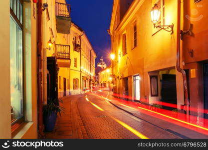 Picturesque Street and luminous track from the car at night in Old Town of Vilnius, Lithuania, Baltic states. Used toning