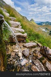Picturesque summer mountain landscape of Durmitor National Park, Montenegro, Europe, Balkans Dinaric Alps, UNESCO World Heritage. Water source near Durmitor panoramic road, Sedlo pass.