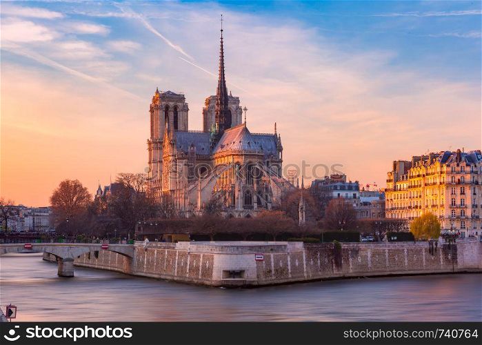 Picturesque sunset over Cathedral of Notre Dame de Paris, destroyed in a fire in 2019, Paris, France. Cathedral of Notre Dame de Paris at sunset, France
