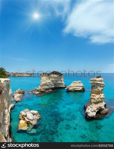 Picturesque sunshiny seascape with cliffs and stacks (faraglioni), at Torre Sant Andrea, Salento sea coast, Puglia, Italy. Two shots stitch image.. Sunshiny Faraglioni at Torre Sant Andrea, Italy