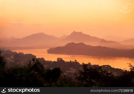 Picturesque the Mekong River and Luang Prabang town at dusk, view from Phou si summit, a tranquil scenery of World Heritage Site, North Laos. Soft focus.