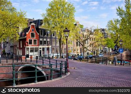 Picturesque traditional Dutch houses and bridge on the Reguliersgracht canal in Amsterdam, Holland, Netherlands.