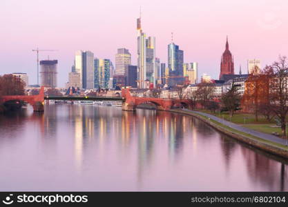 Picturesque view of business district with skyscrapers and mirror reflections in the river at sunrise, Frankfurt am Main, Germany