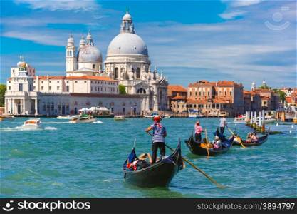 Picturesque view of Gondolas on Canal Grande with Basilica di Santa Maria della Salute in the background, Venice, Italy. Selective focus on Gondolier