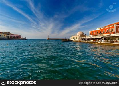 Picturesque view of old harbour of Chania with Lighthouse and Kucuk Hasan Pasha Mosque in summer day, Crete, Greece