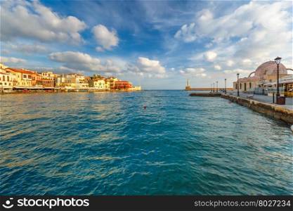 Picturesque view of old harbour of Chania with Lighthouse and Kucuk Hasan Pasha Mosque in summer morning, Crete, Greece
