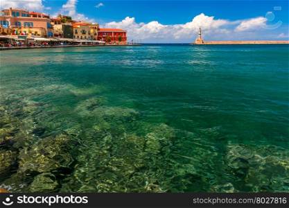 Picturesque view of old harbour of Chania with Lighthouse and Venetian quay in summer day, Crete, Greece