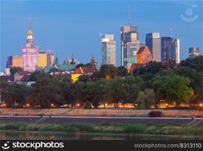 Picturesque view of the central part of Warsaw and the city embankment in the evening. Poland.. Warsaw. View of the city and city embankment at sunset.
