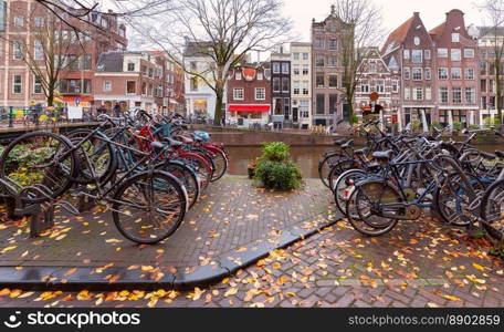 Picturesque view of the city embankment and the facades of medieval fairy-tale houses in winter. Amsterdam. Netherlands.. Beautiful old houses on the city embankment of Amsterdam on a winter day.