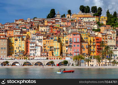 Picturesque view of the multicolored medieval houses in the historic part of the city. Menton. France. Cote d&rsquo;Azur.. Menton. Antique multi-colored facades of medieval houses on the shore of the bay.