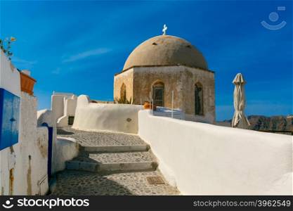 Picturesque view of white houses and church in Oia or Ia, island Santorini, Greece