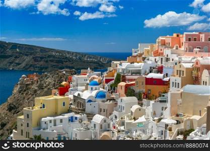 Picturesque view of white houses and church with blue domes in Oia or Ia, island Santorini, Greece. Picturesque view of Oia, Santorini, Greece