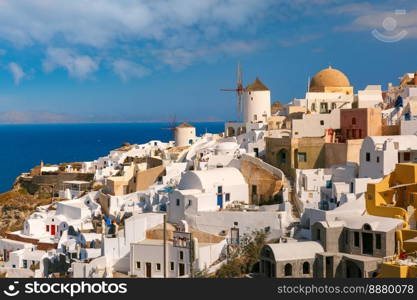 Picturesque view of windmills and white houses in Oia or Ia on the island Santorini, Greece. Windmill and white houses, Oia, Santorini, Greece