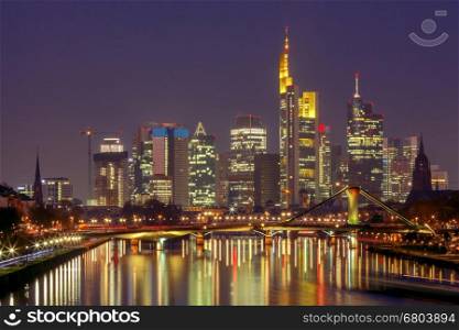 Picturesque views of the city's waterfront and skyscrapers at night in Frankfurt. Germany.