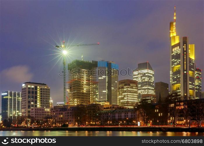 Picturesque views of the city's waterfront and skyscrapers at night in Frankfurt. Germany.