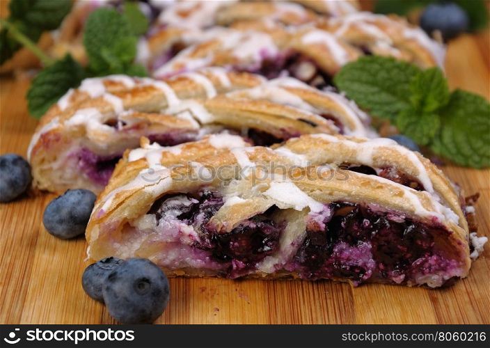 Pie stuffed with cheese cream , blueberry, crushed peanuts dough braided plait