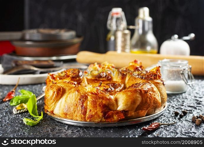 Pie with cheese and ham in baking dish.