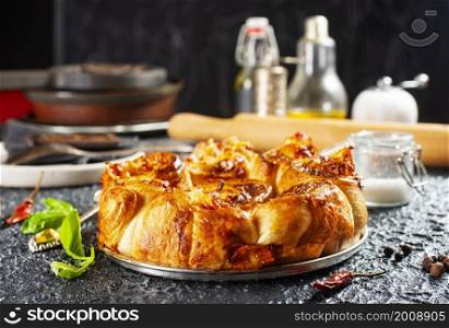 Pie with cheese and ham in baking dish.