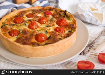 pie with cheese brie and cherry tomatoes - french cuisine