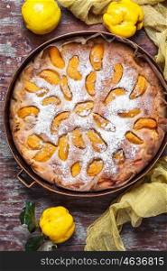 Pie with quinces. Homemade pie stuffed with autumn quince in rustic style