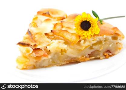 piece of apple pie and a flower isolated on white