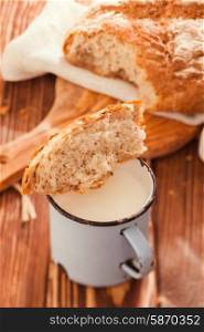 Piece of bread and cup of milk. Morning rustic still life. Morning rustic still life