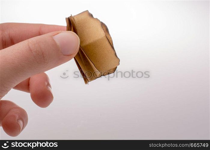 Piece of burnt paper on a brown background