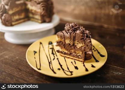 Piece of cake on the plate, culinary masterpiece on wooden background. Homemade cooking dessert. Piece of cake on the plate, culinary masterpiece