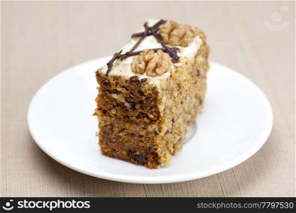 Piece of cake with nuts lying on the plate