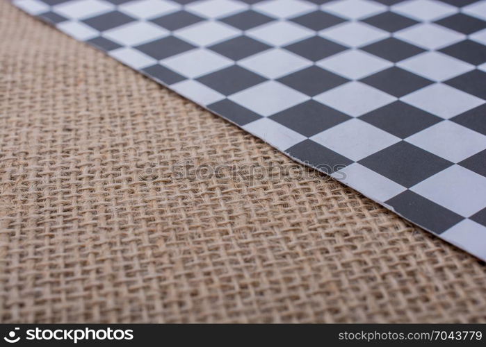 Piece of checked paper on a linen canvas