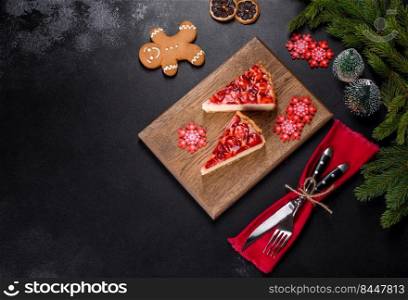 Piece of delicious homemade fresh strawberry pie on a holiday christmas table. Delicious christmas strawberry tart on concrete background, top view, copy space