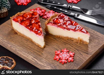 Piece of delicious homemade fresh strawberry pie on a holiday christmas table. Delicious christmas strawberry tart on concrete background, top view, copy space