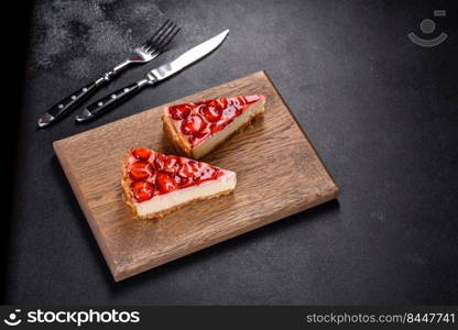 Piece of delicious homemade fresh strawberry pie on a holiday table. Delicious strawberry tart on concrete background, top view, copy space